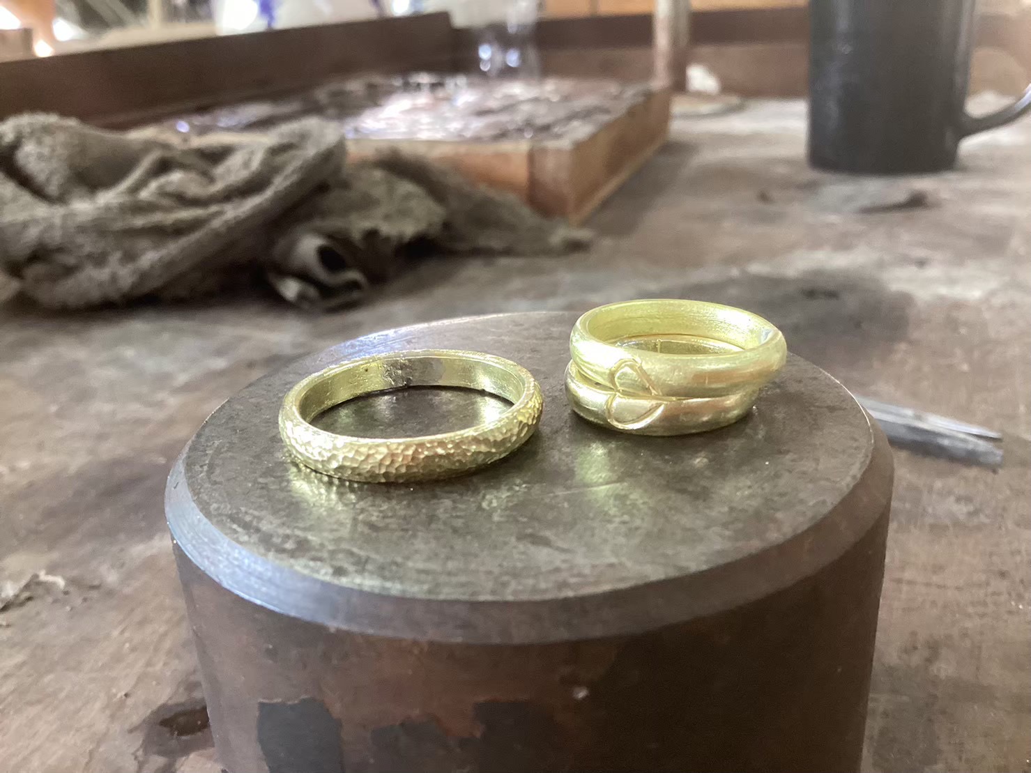 Two gold rings on bench block