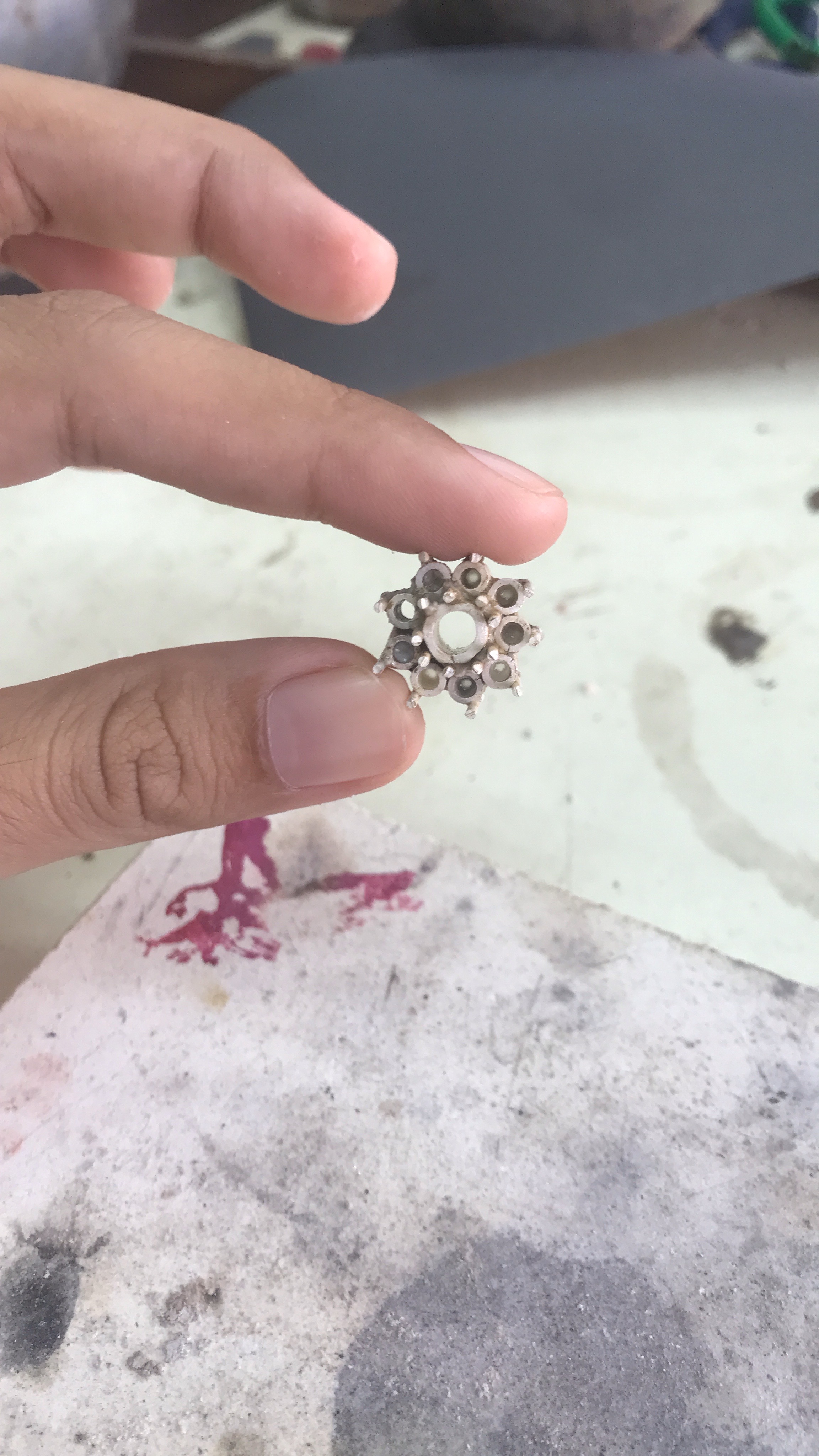 Small flower part held in fingers