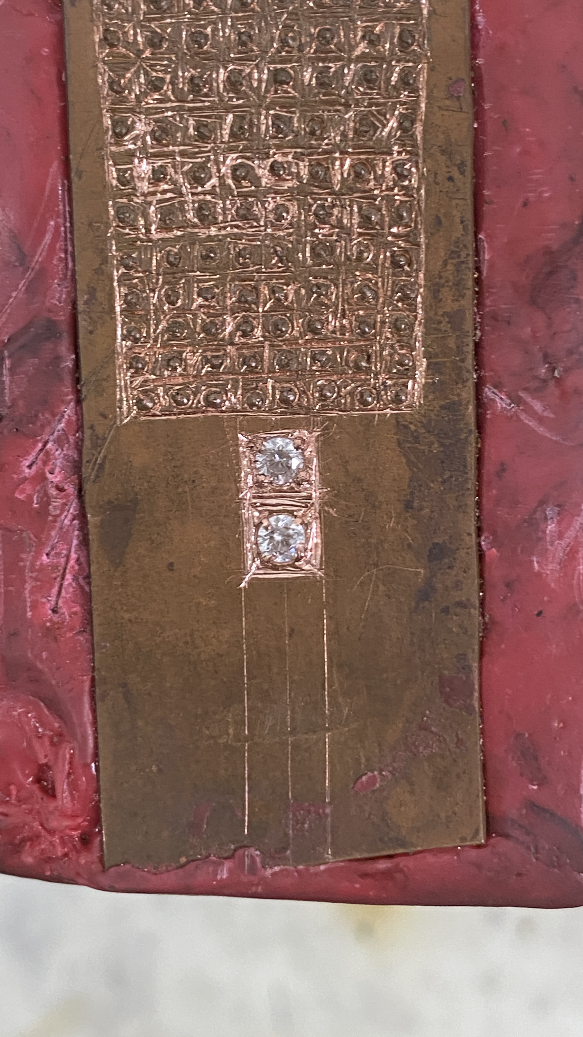Engraved copper plate with stones