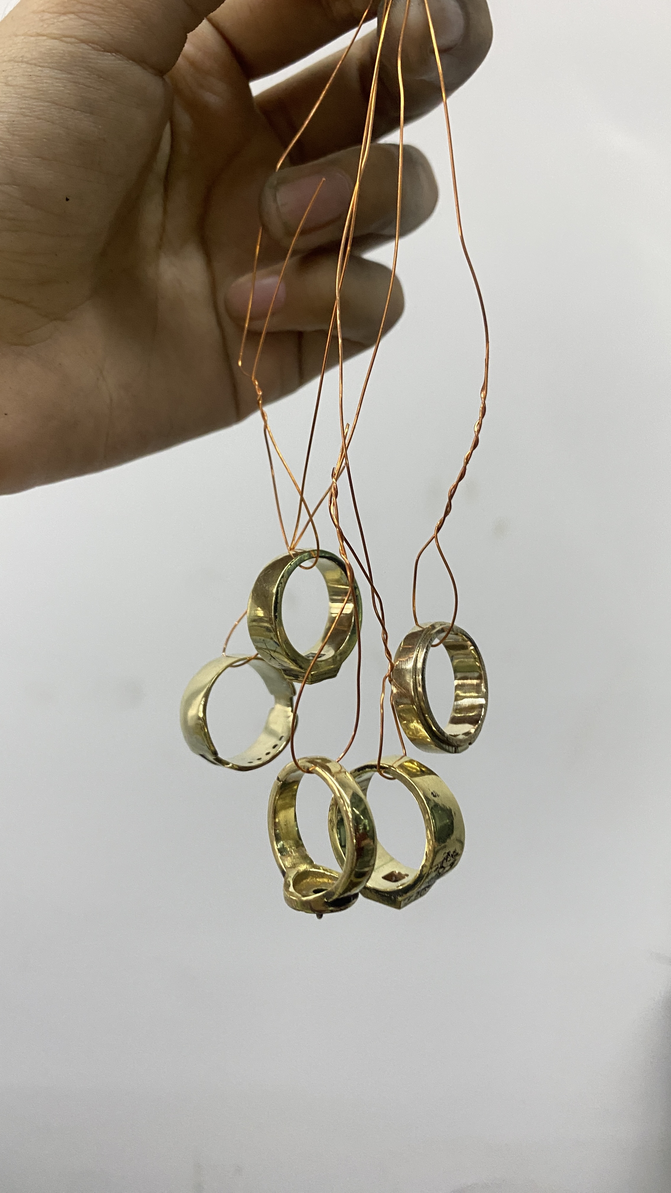 Rings hanging on copper wires for electroplating